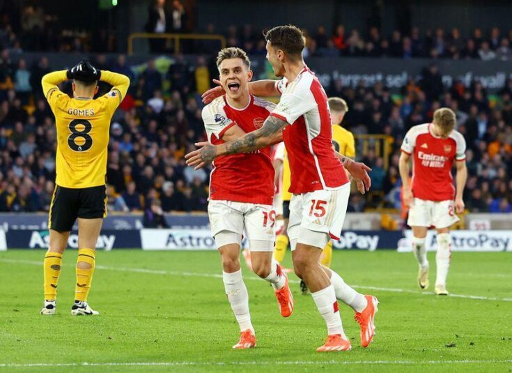 Soccer-Arsenal go top of Premier League with dour 2-0 win over Wolves